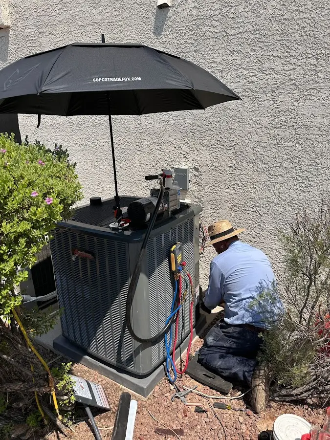 HVAC technician performing outdoor AC maintenance in Seven Corners